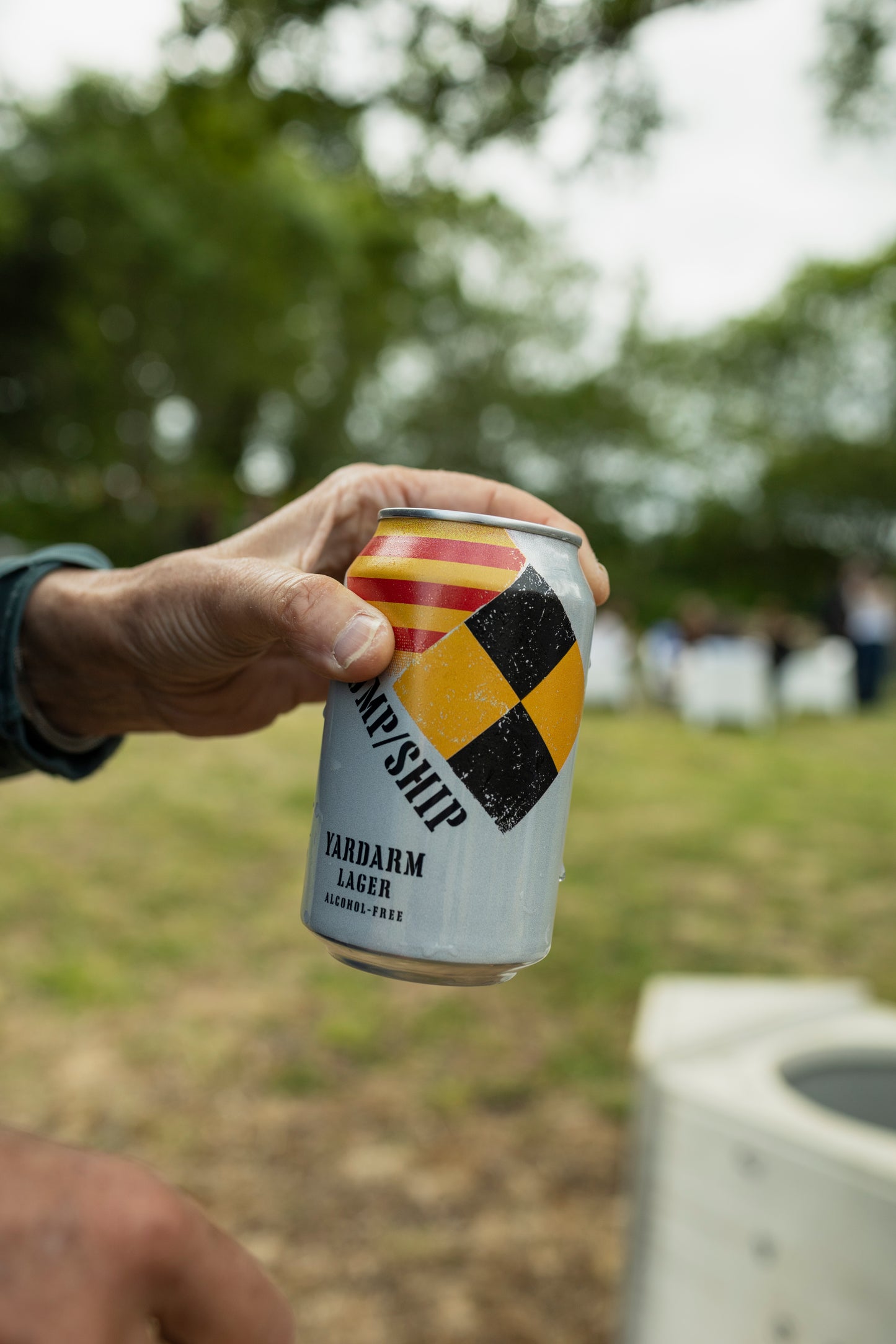 Hand holding a can Yardarm Lager