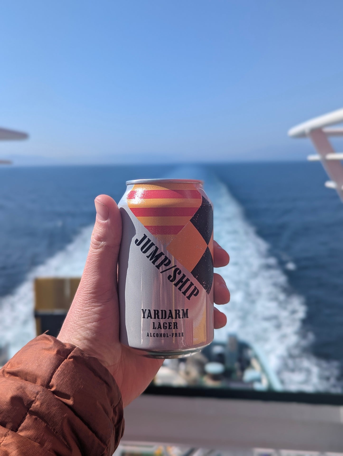 Holding a can of Yardarm non alcoholic lager on the back of a Scottish ferry.