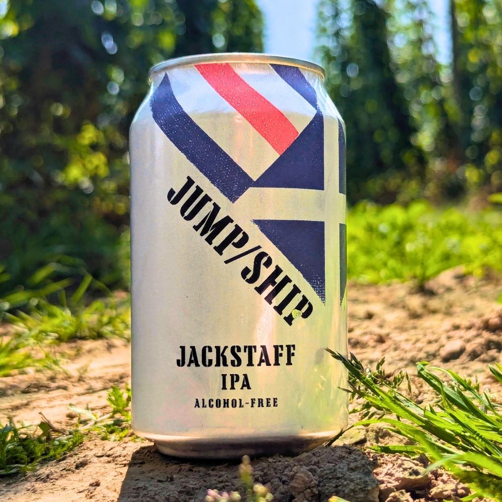 Can of Jackstaff IPA with 'Jump/Ship' branding in a field of hops