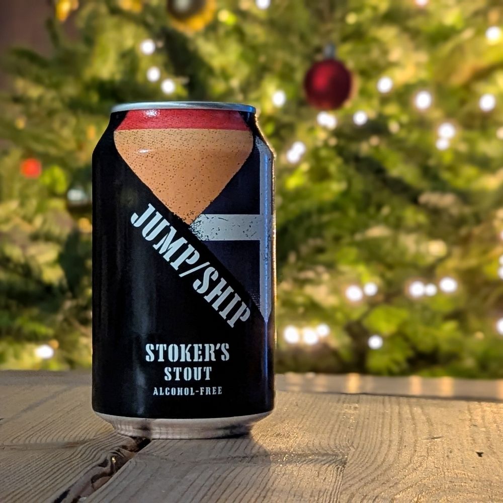 Can of Stoker's Stout with 'Jump/Ship' branding against a Christmas tree background