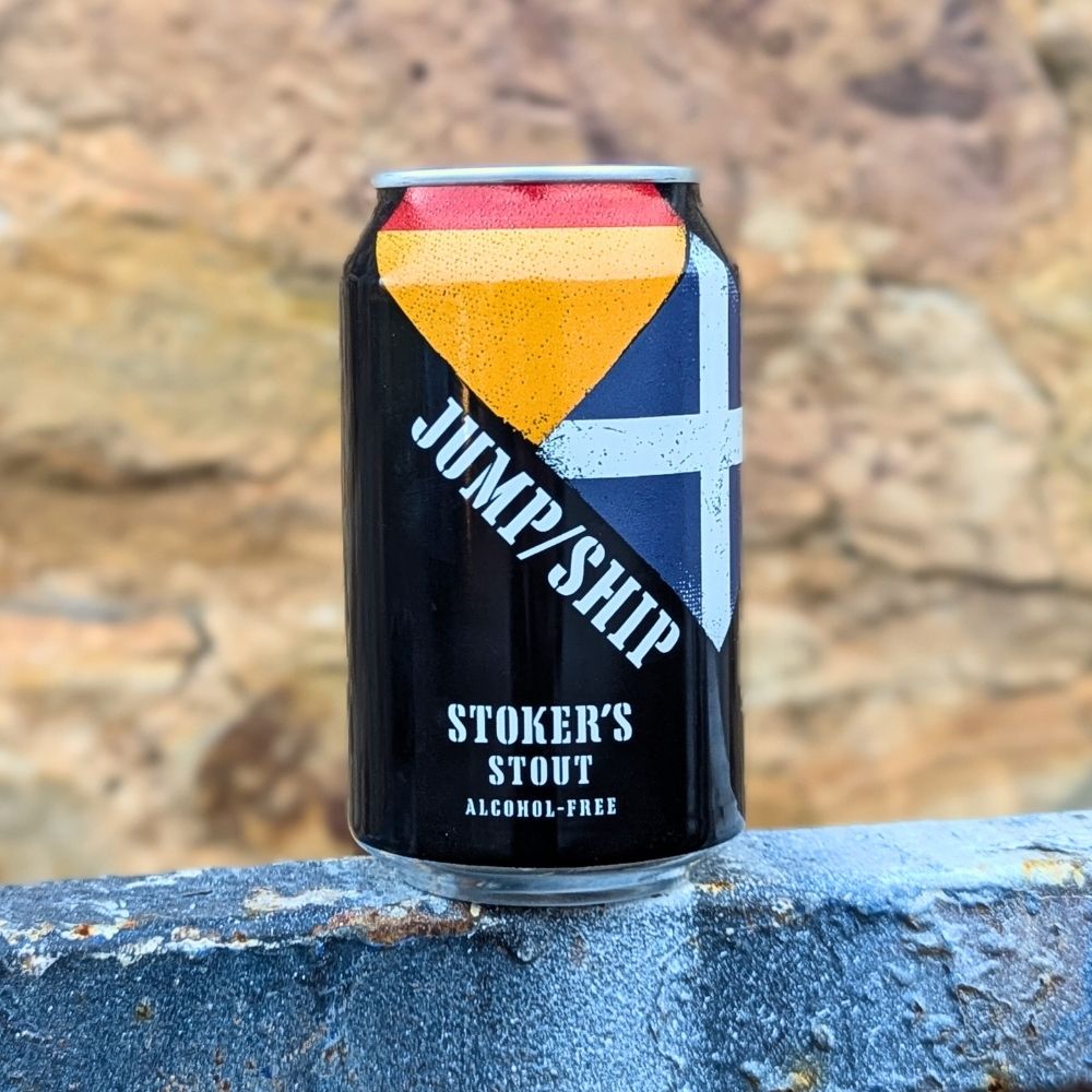 Alcohol-free Stout can with 'Jump/Ship' branding on a stone surface.