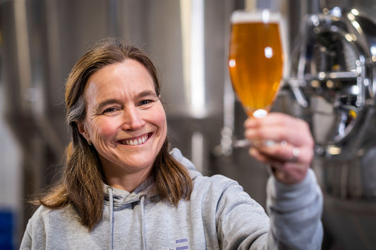 Founder in brewery with alcohol free beer in glass