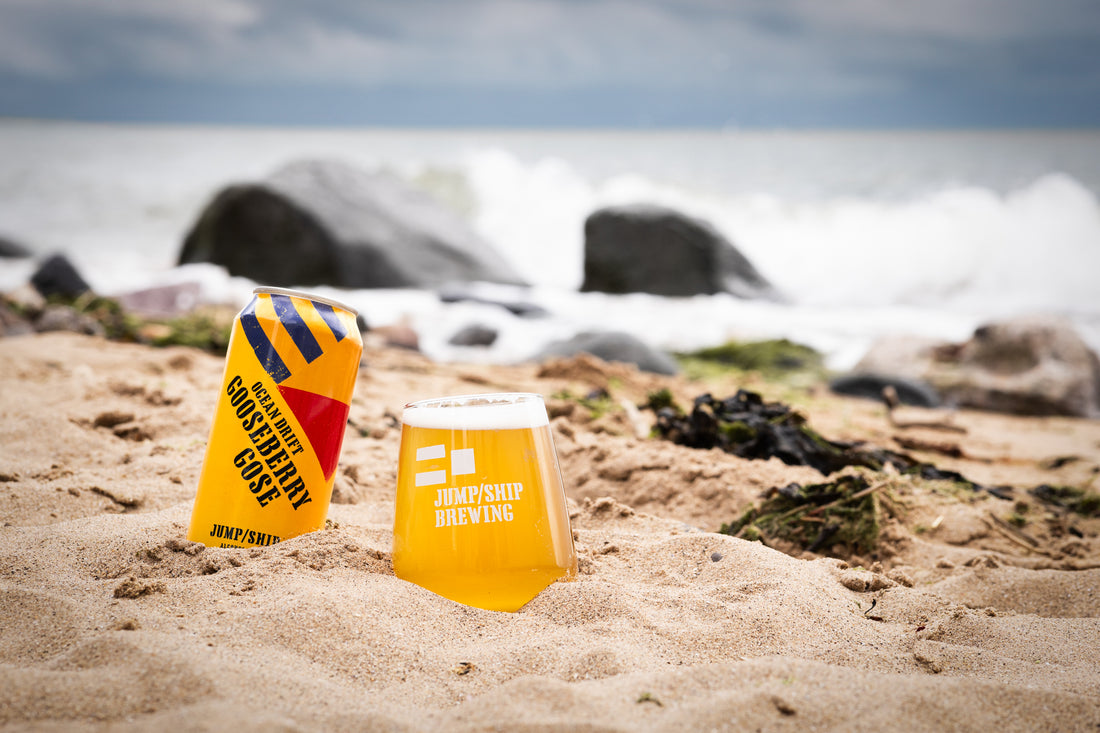 Ocean Drift Gooseberry Gose alcohol free beer can and glass on the beach