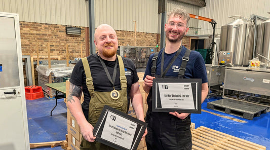 Brewers Pete and Alex hold the Jump Ship Indie Beer Awards certificates and medals