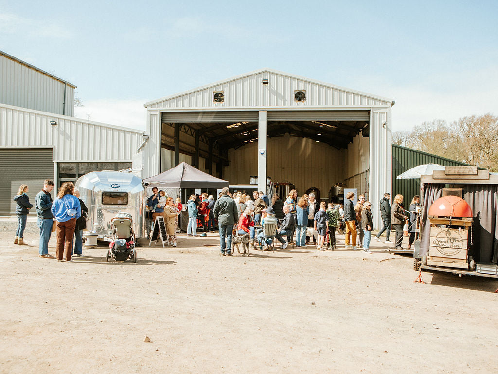 People eating and drinking alcohol free beer at Rosemains Steading market