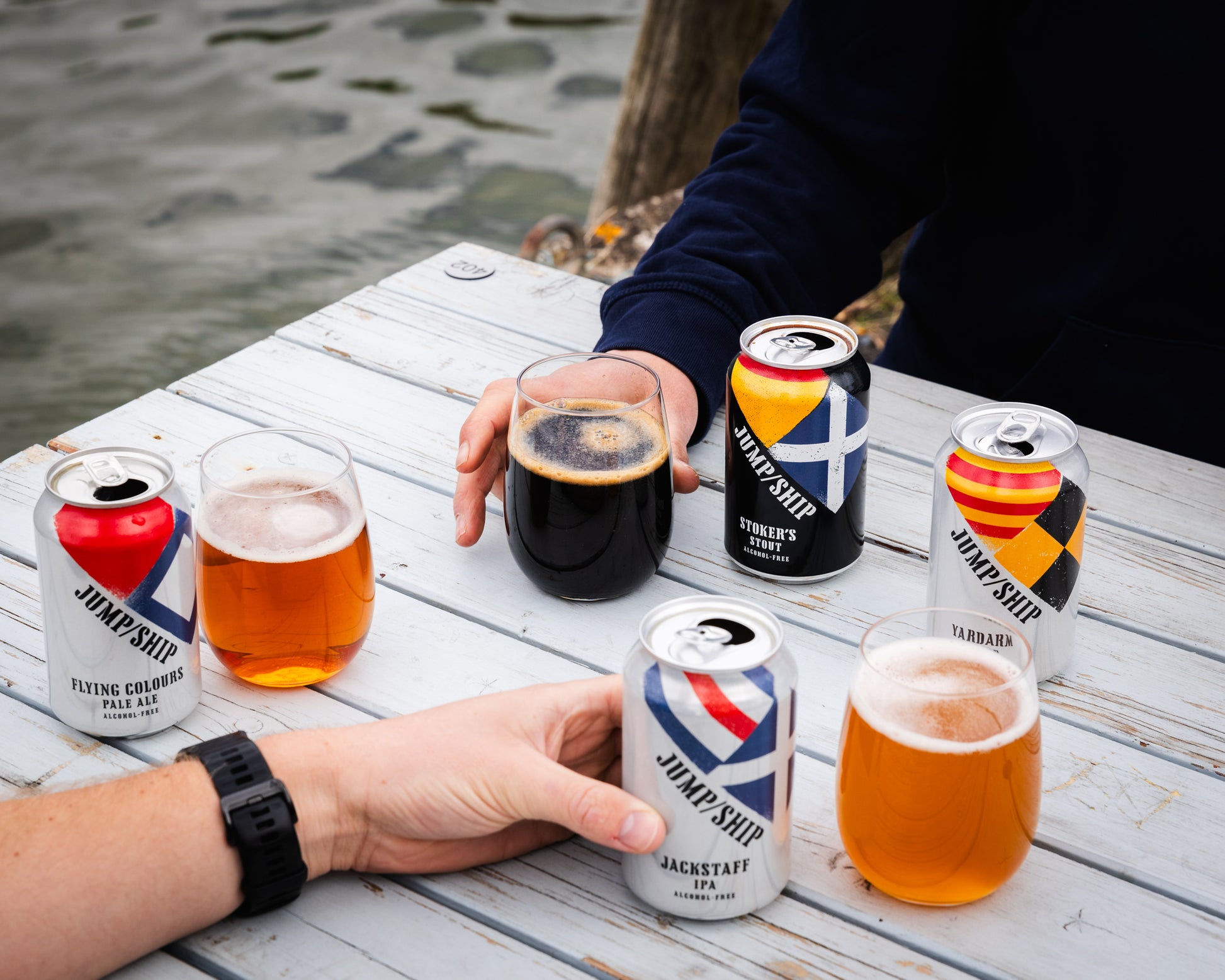 Alcohol free beer mixed pack cans on table with glasses