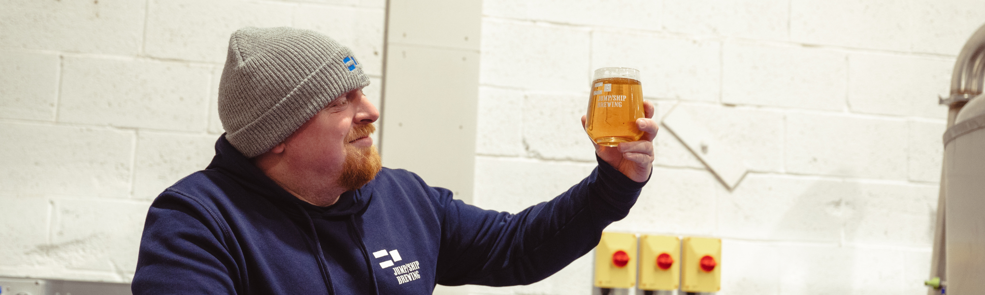 Head brewer Pete holds a glass of alcohol free beer