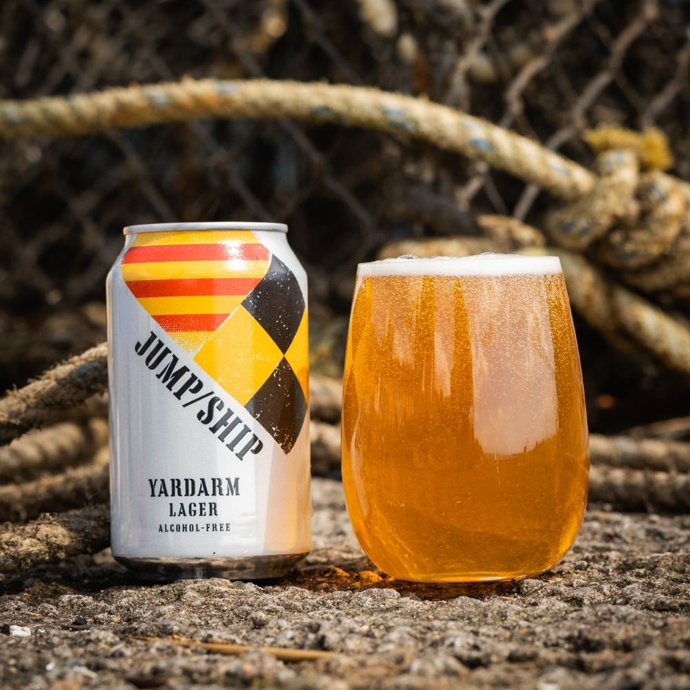Can and glass of Yardarm Lager with a rope and net background